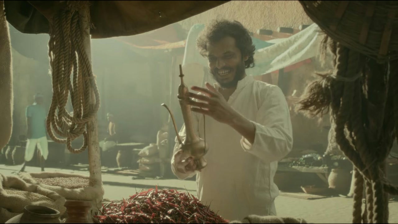 Still from the HDFC Bank spec ad: a man at a market stall holding a brass jug, red chillies on the table